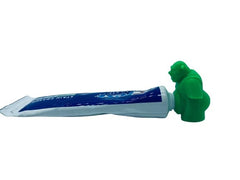 Daodan Shrek Pooping Toothpaste Cap atop a travel-size toothpaste