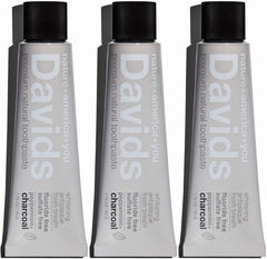 Person brushing teeth with Davids charcoal toothpaste