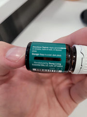 Hands applying Deep Relief 5 ml essential oil blend
