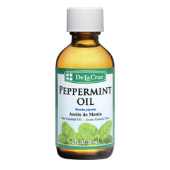 De La Cruz Peppermint Essential Oil bottle with label 2 oz