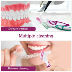 Denture cleaning brush being used on false teeth