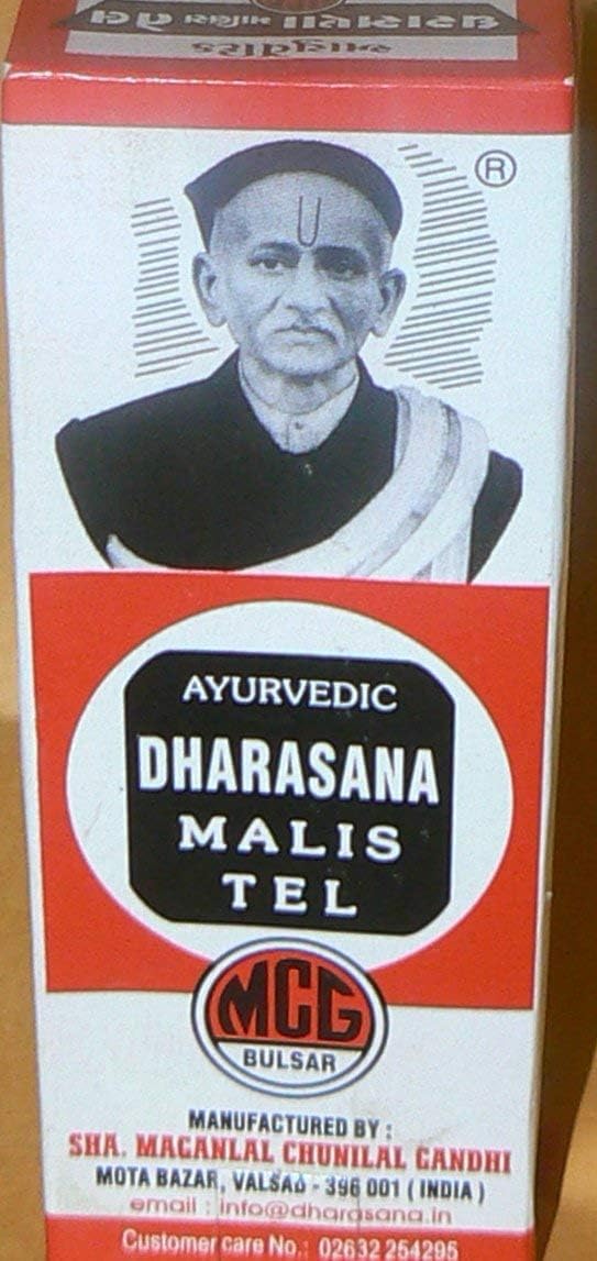 Hands applying Dharasana Ayurvedic massage oil