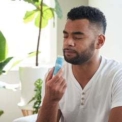 Applying doTERRA Breathe Vapor Stick to the chest