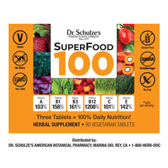 Close-up of SuperFood 100 greens powder in a scoop beside the bottle