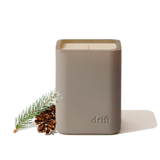 Drift Frosted Spruce/Pine scented candle in a minimalist glass jar on a wooden surface