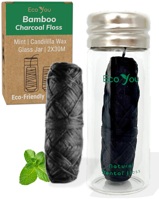 Glass container holding EcoYou charcoal bamboo floss