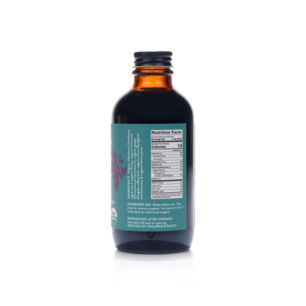 Amber glass bottle of Fields Without Fences Elderberry Elixir with aluminum cap