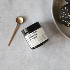 Using activated charcoal powder for teeth whitening on a toothbrush
