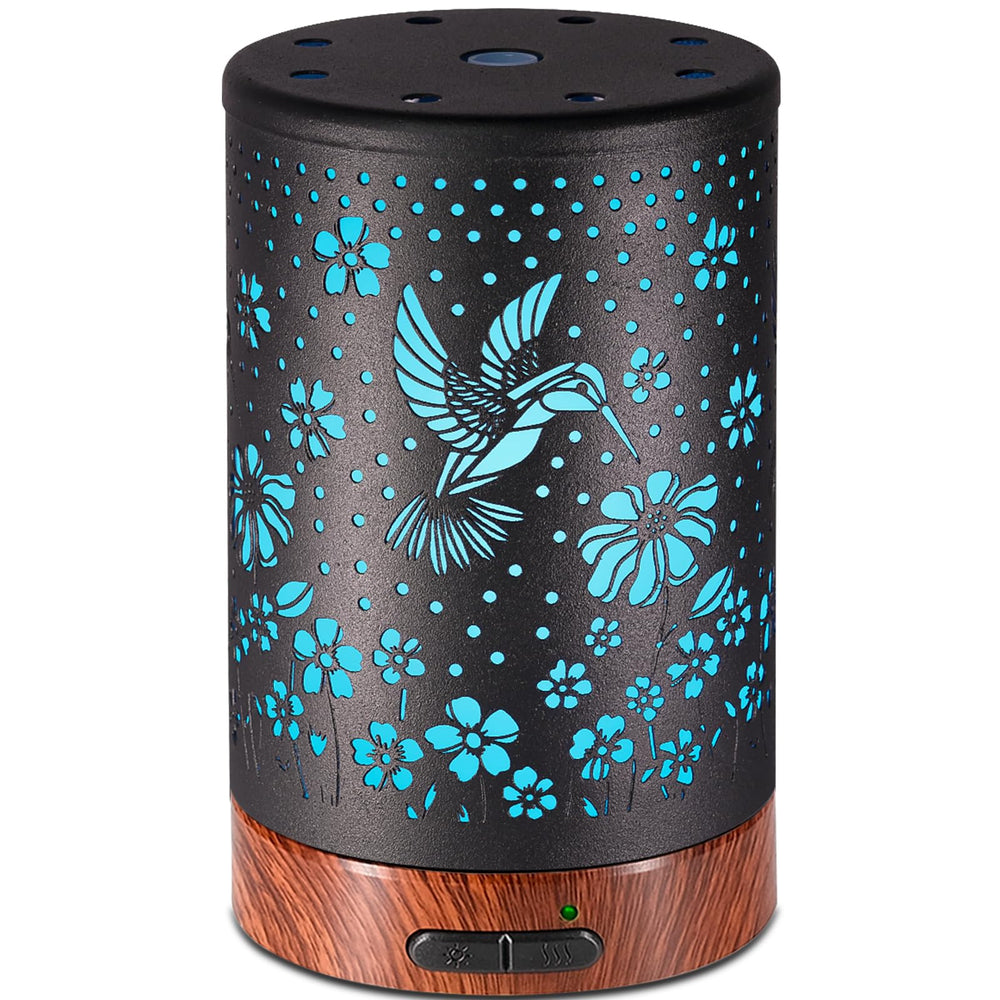 Metal-covered essential oil diffuser with hummingbird pattern on nightstand