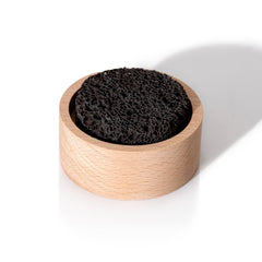 Applying essential oil drops to lava rock diffuser