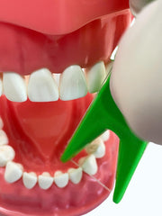 Child using E-Z Floss Holder with floss and Mr Flossman