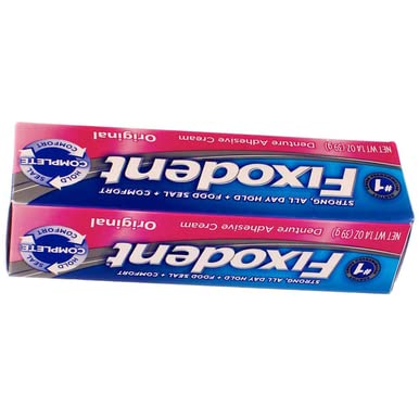 Denture being secured with Fixodent Original adhesive