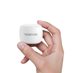 Flowtune mini portable sound machine held in hand for travel and on-the-go sleep