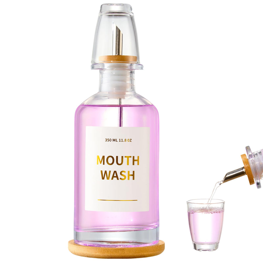 Glass mouthwash dispenser on a bamboo tray for bathroom decor