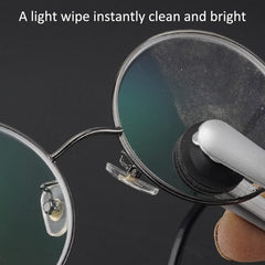 Glasses cleaner with retractable dust brush in use