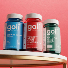 Goli gummies in hand in urban setting illustrating on-the-go supplement convenience