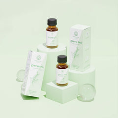 Vial of Green Tea Essential Oil on neutral background