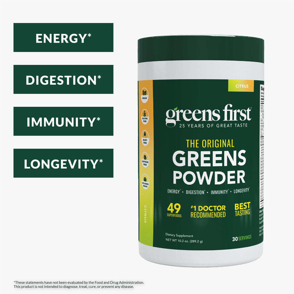 Close-up scoop of Greens First powder showing orange citrus flavor