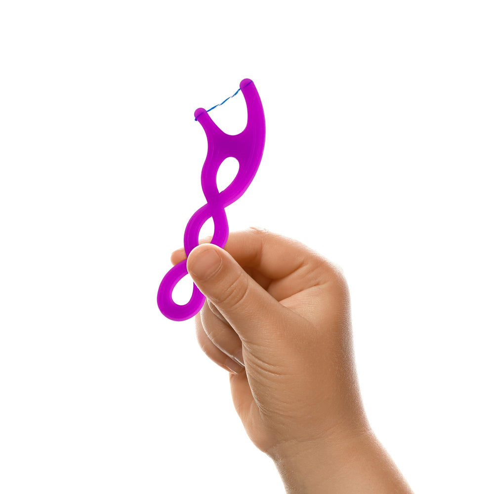 Child using floss picks to clean between teeth