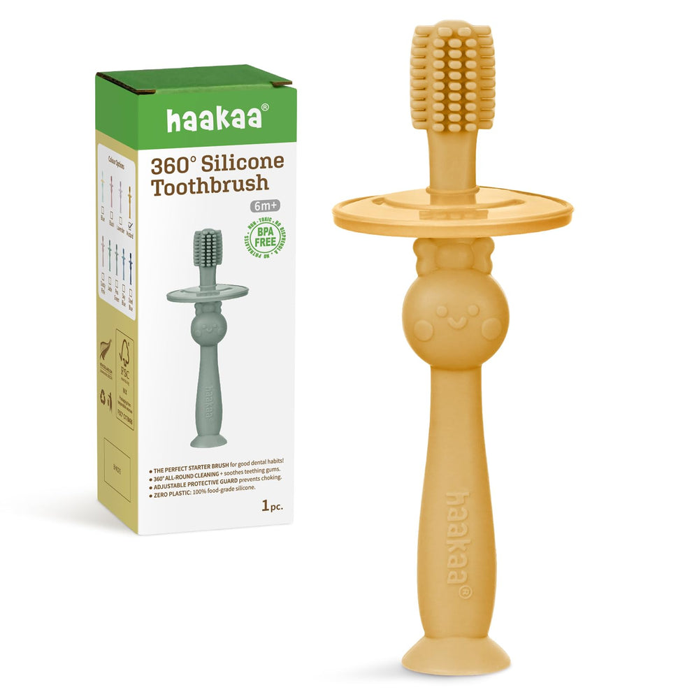 Haakaa 360° Baby Toothbrush with suction base in mustard color