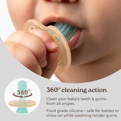 Baby holding Haakaa 360° silicone toothbrush pink