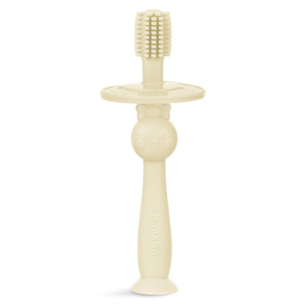 Cream Haakaa infant toothbrush with 360° bristle coverage