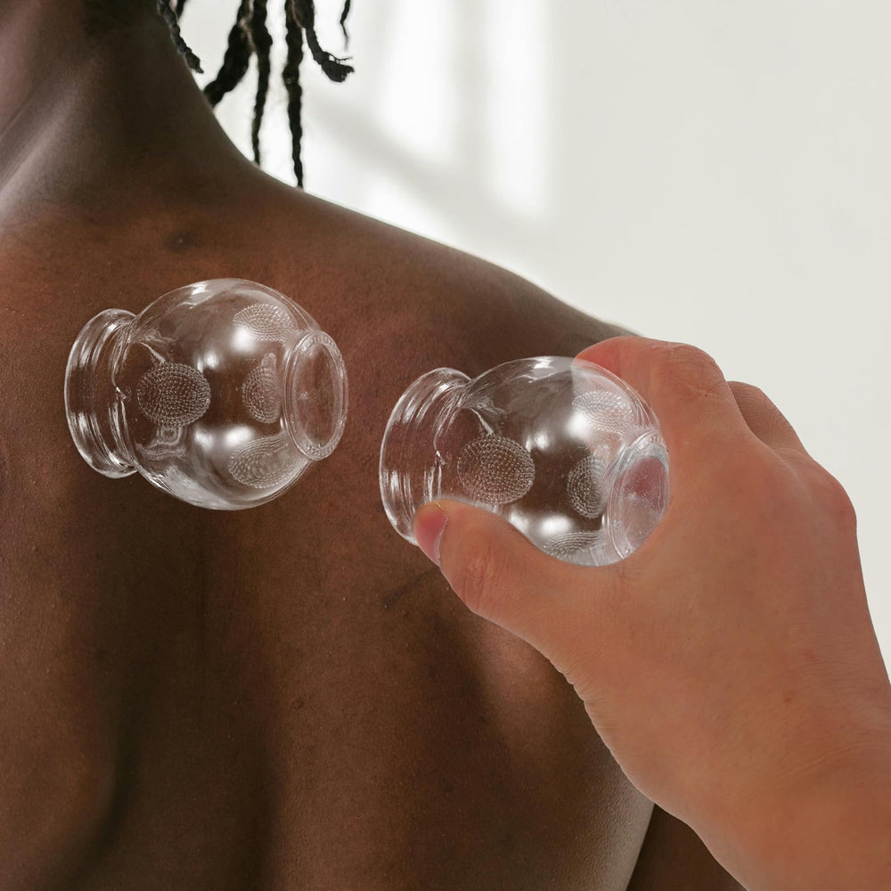 Set of 8 glass cupping cups displayed together