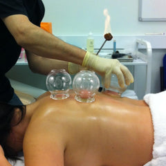 Transparent glass cupping set in a spa-like setting