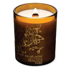 Close-up of amber glass candle showing the wood wick