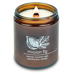 Hemlock Park candle in an amber glass jar with a wooden wick