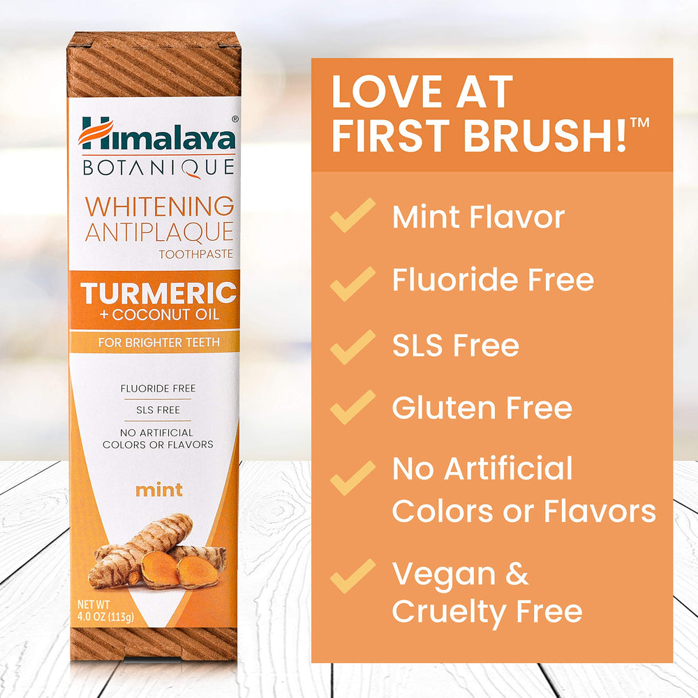 Golden turmeric root beside toothpaste for whitening