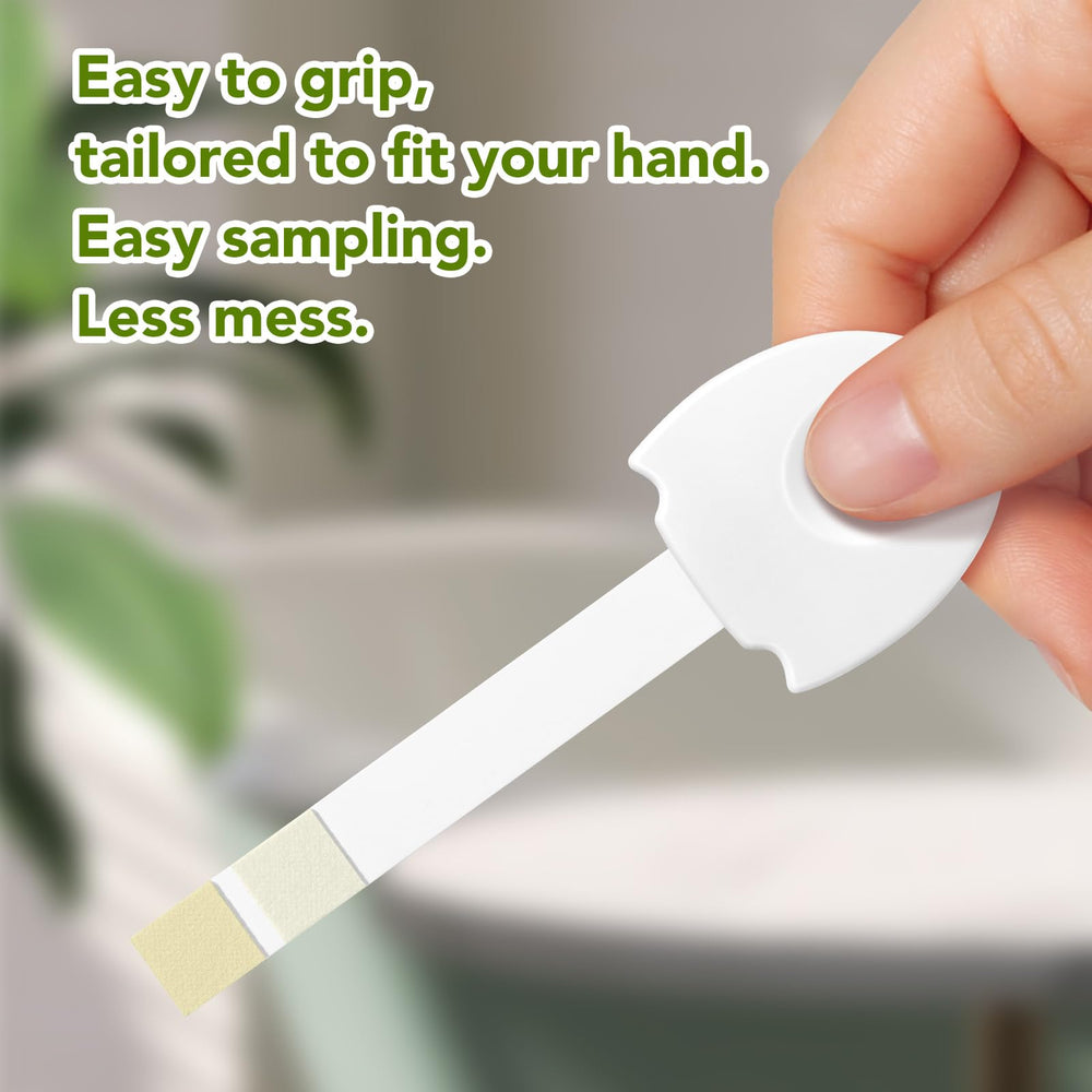 Person using UTI test strips at home for testing