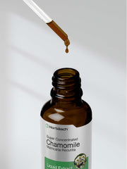Chamomile herb and Horbaach bottle together photograph