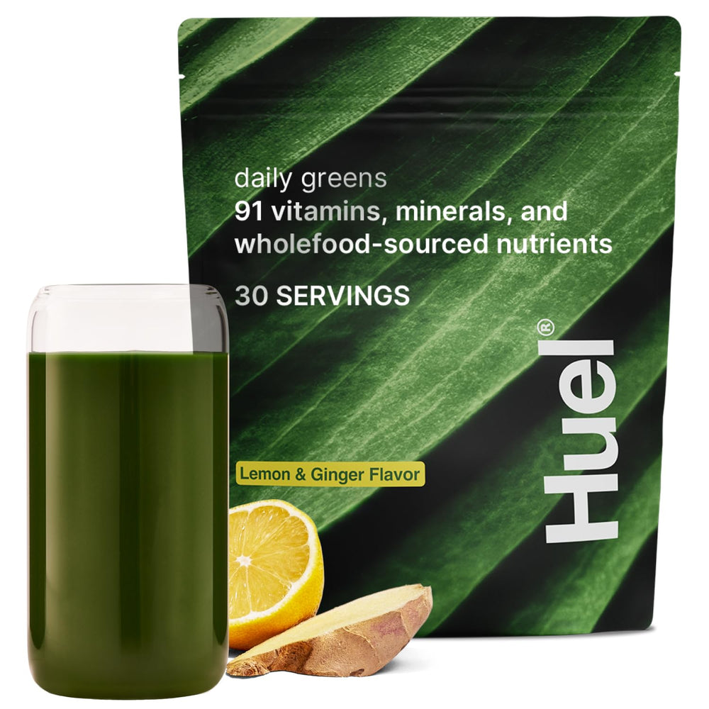 Huel Daily Greens Lemon & Ginger tub close-up with vibrant powder for daily nutrition