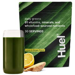 Huel Daily Greens Lemon & Ginger tub close-up with vibrant powder for daily nutrition