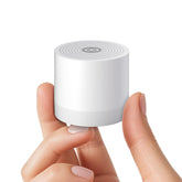 Hushing mini sound machine compact design on table for portable sleep aid