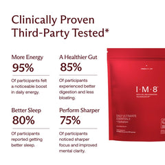 IM8 Daily Ultimate Essentials scoop mid-air, ready to mix into your drink.