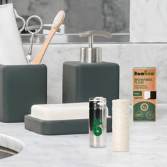 Person using vegan dental floss with stainless steel dispenser