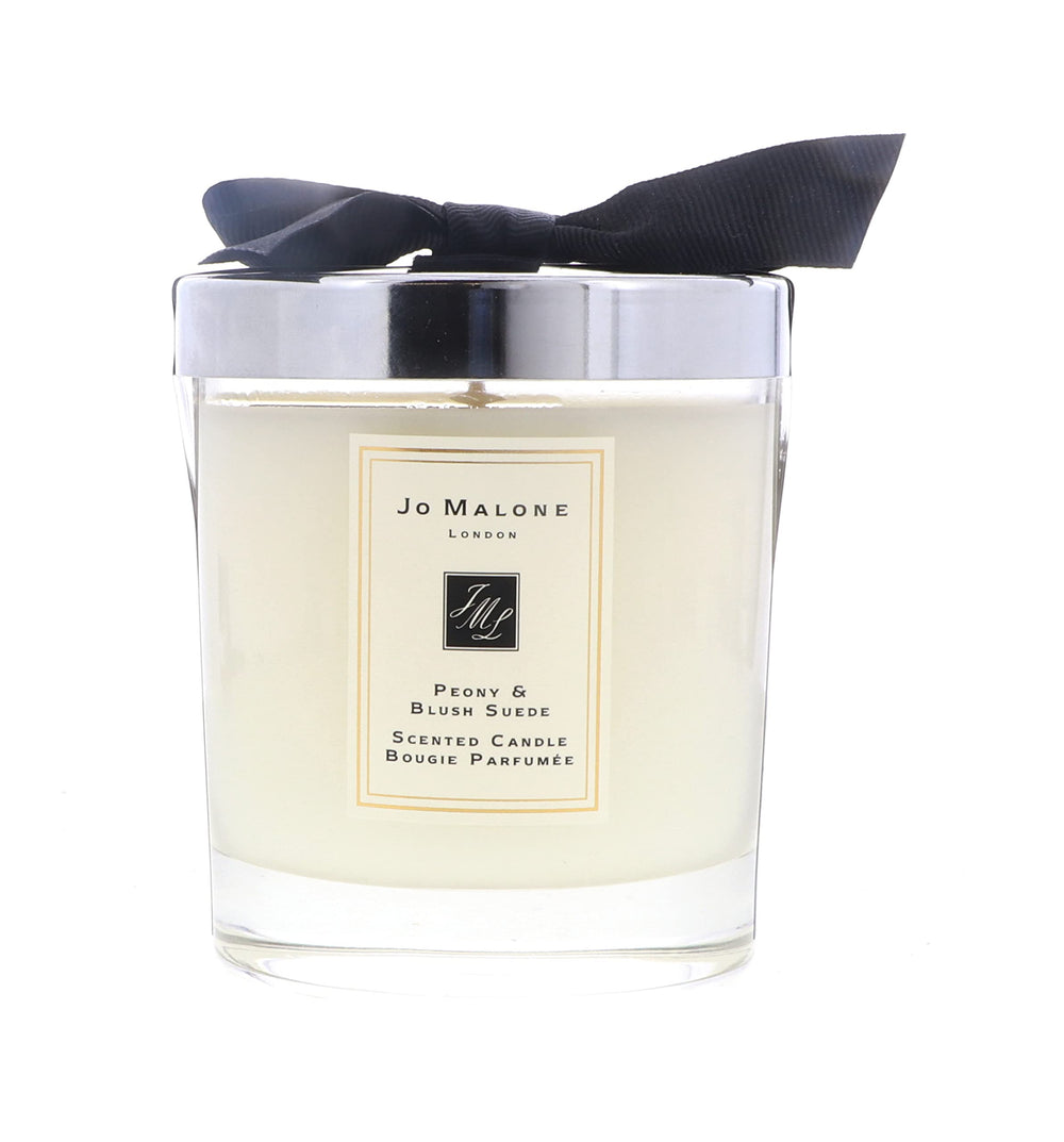Jo Malone Peony & Blush Suede candle with peony bloom creates luxurious room ambience.
