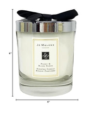 Jo Malone Peony & Blush Suede candle in signature glass enhances refined decor and atmosphere.
