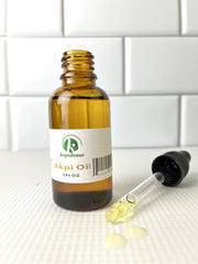 Glass bottle of Akpi oil, cold-pressed process