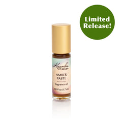 Amber paste fragrance oil roller being applied