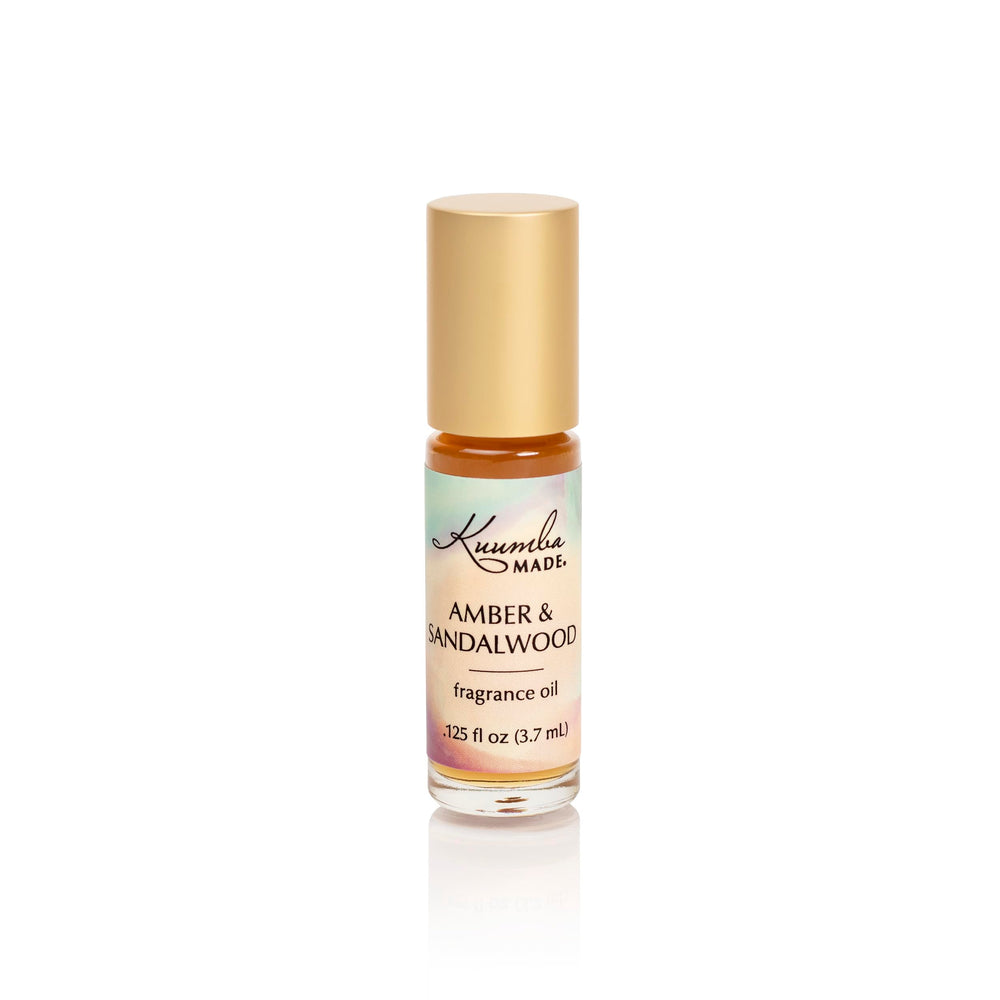 Kuumba Made Amber and Sandalwood roll-on bottle for on-the-go, long-lasting fragrance.