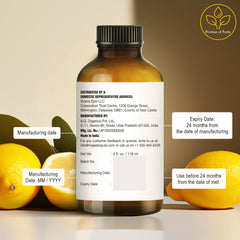 Lemon slices beside Majestic Pure Lemon Essential Oil bottle