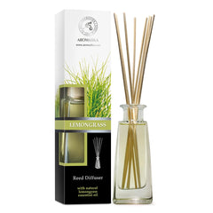 Lemongrass diffuser bottle and reeds on a white surface