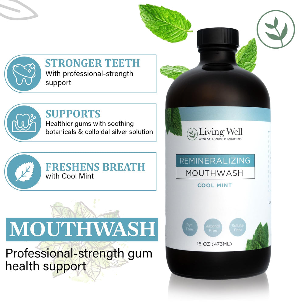 Mouthwash bottle and glass on bathroom counter