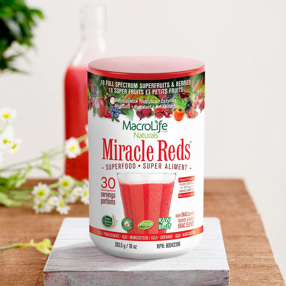Daily-use scoop beside fresh fruits with Miracle Reds