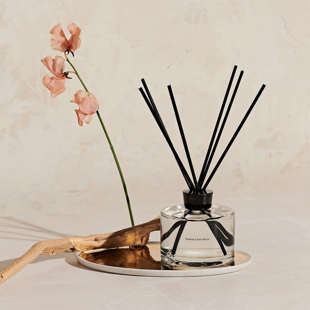 Close-up of diffuser bottle and natural reeds