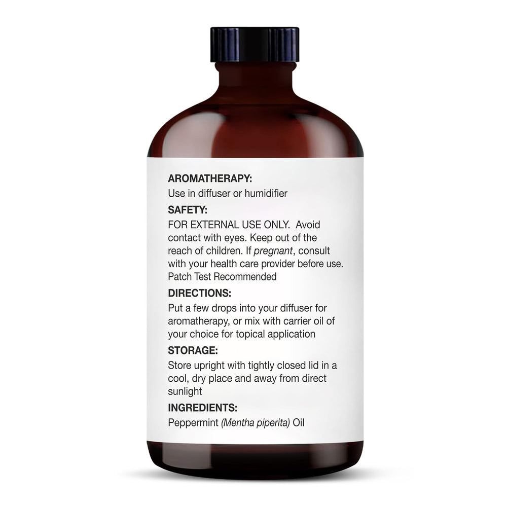 Glass dropper dispensing peppermint essential oil