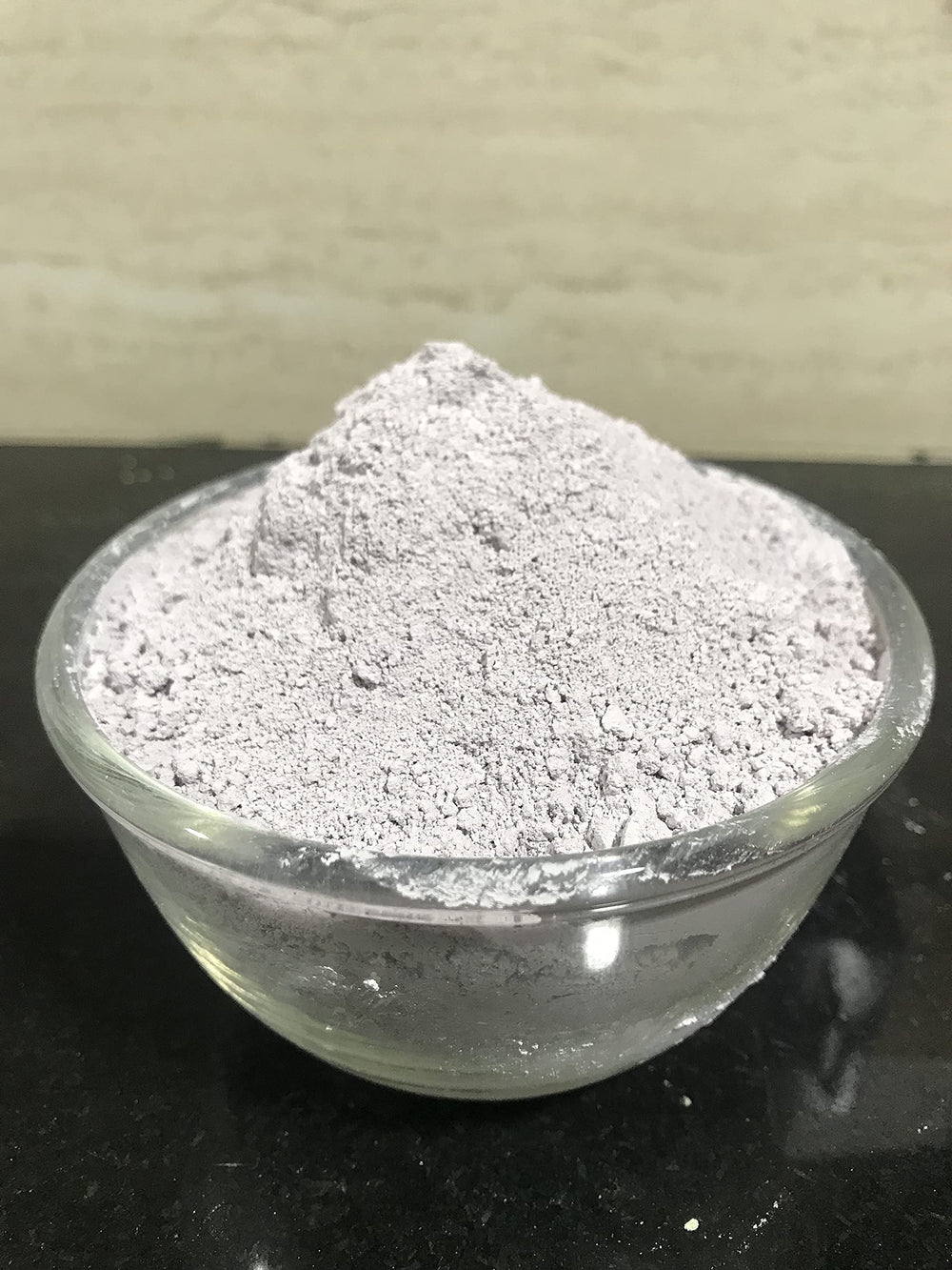 mGanna purple clay powder being mixed for a DIY face mask